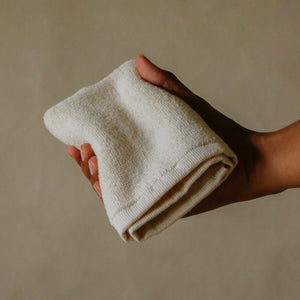Pack of four soft terry cotton face towels with zero-twist texture, plush and highly absorbent.