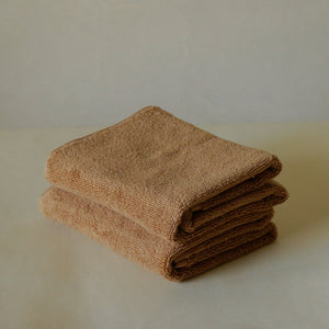Pack of two soft terry cotton hand towels with zero-twist texture, plush and highly absorbent.