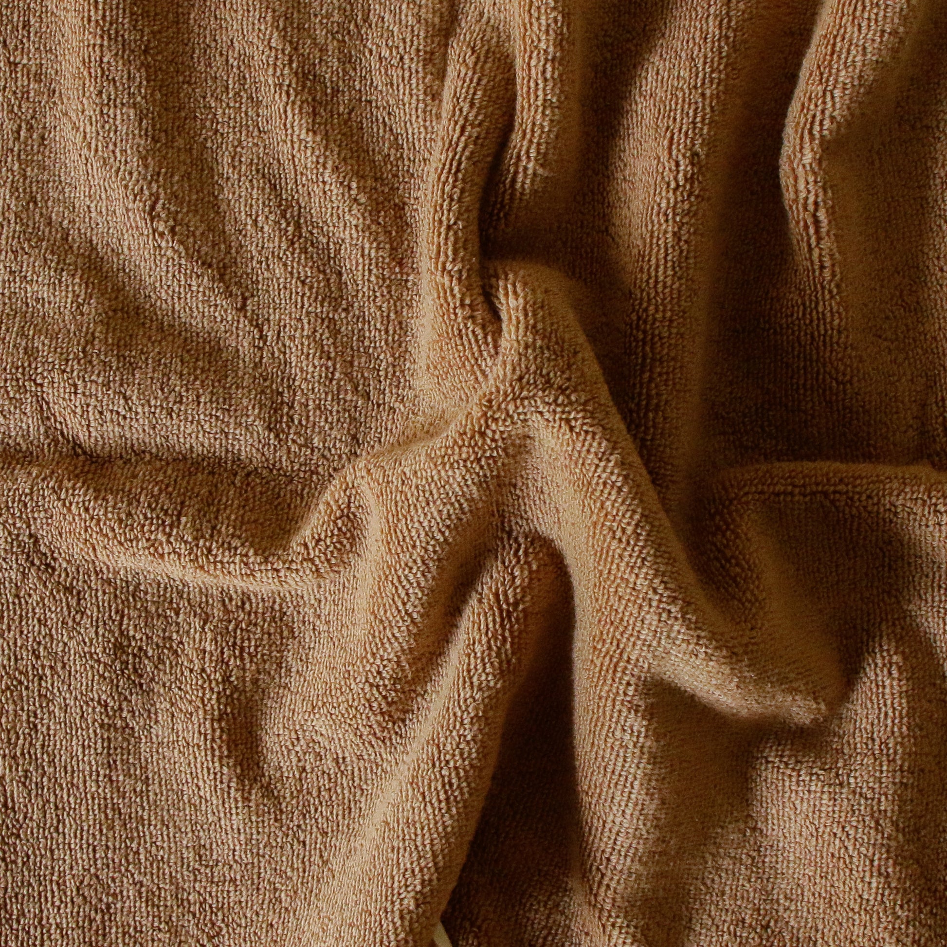 Light-colored soft terry cotton towel set with bath, hand, and face towels, plush and highly absorbent.