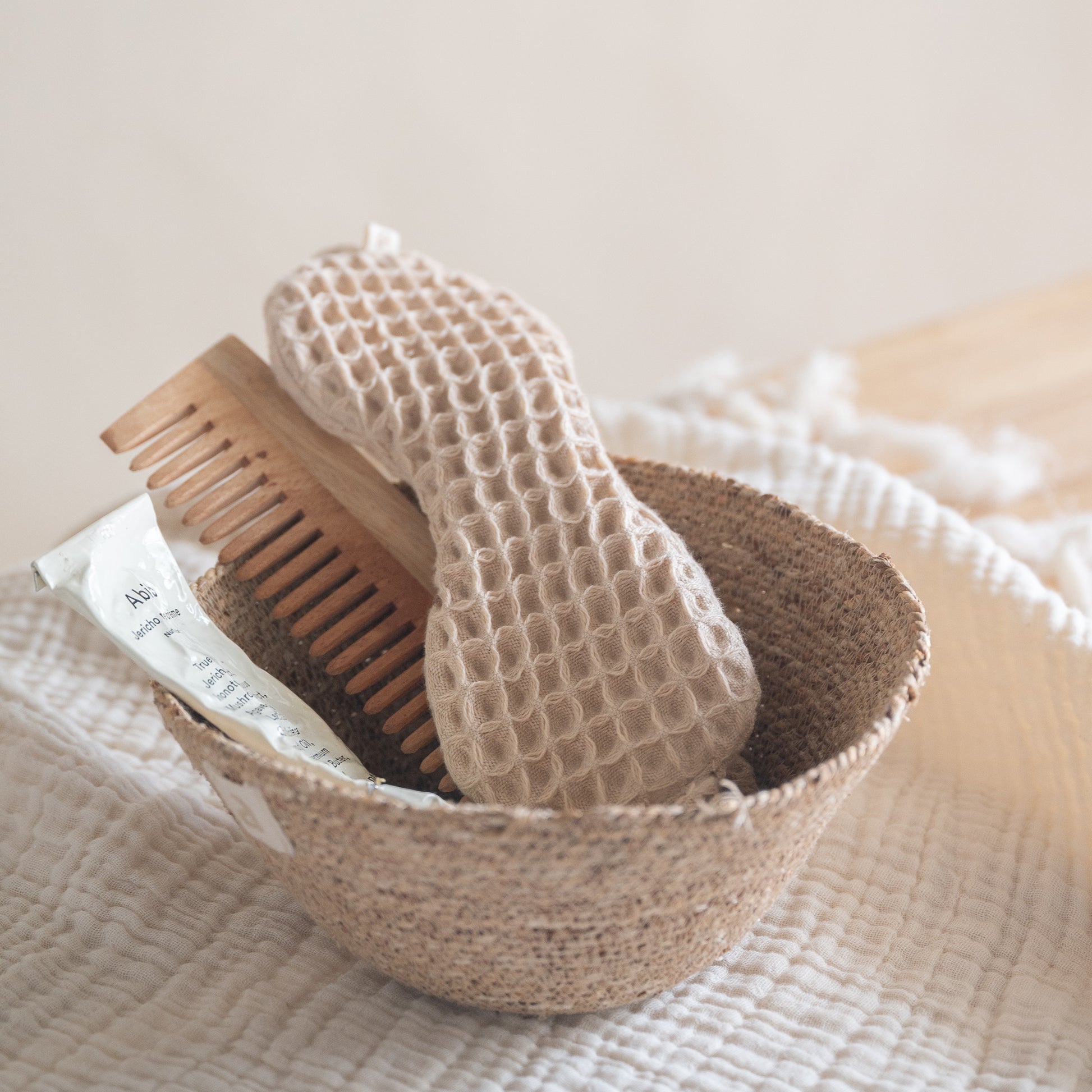 Cotton waffle sleep mask with textured pique fabric, elasticated band, and matching pouch.