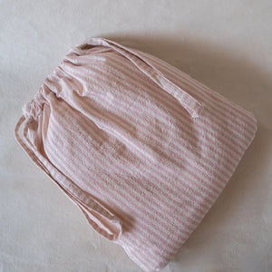 Petal-pink crinkle cotton travel set with two packing cubes, shoe bag, and laundry bag, flat lay