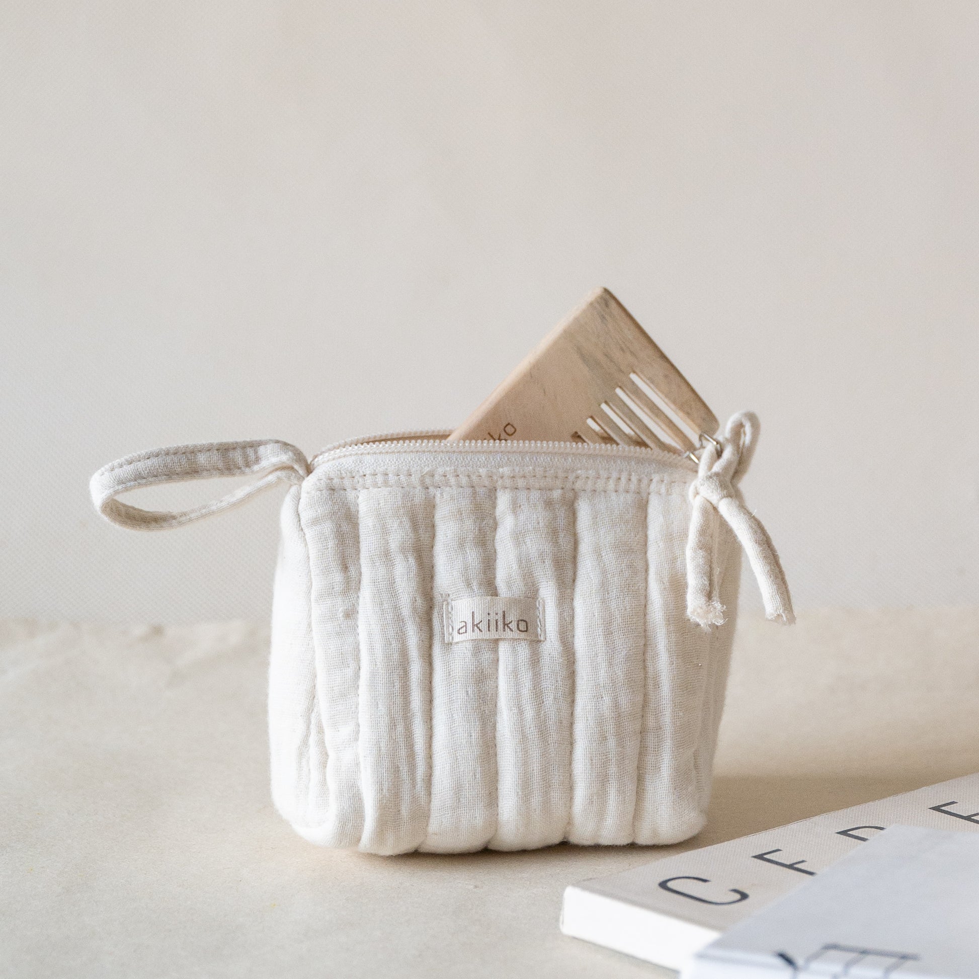 Set of three quilted muslin triangle pouches with zip closures, side view