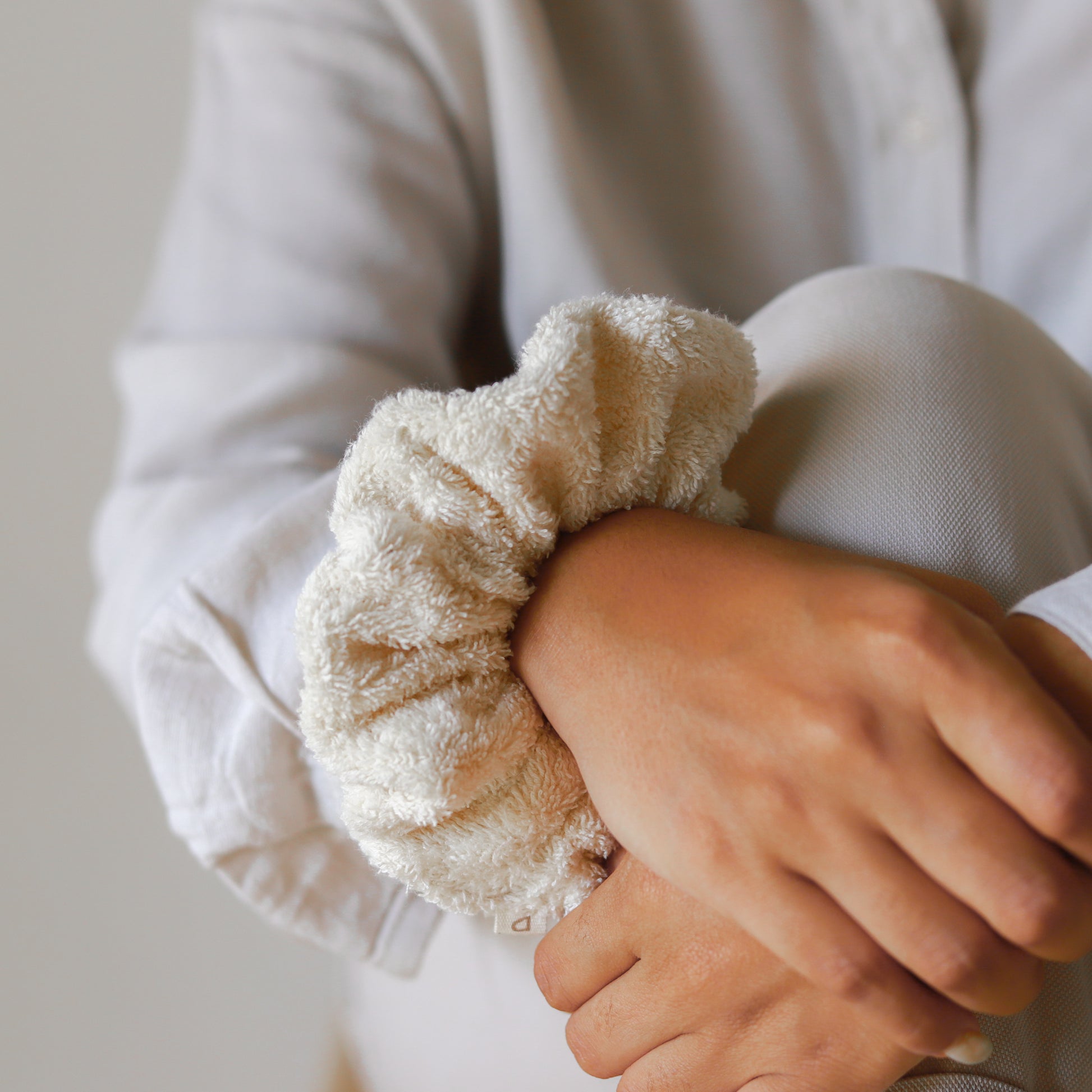 Set of three fluffy terry cotton cloud scrunchies in neutral tones, soft and lightweight, with storage bag.